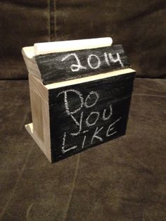 a wooden box with writing on it that says, do you like? and the word joy written in white chalk