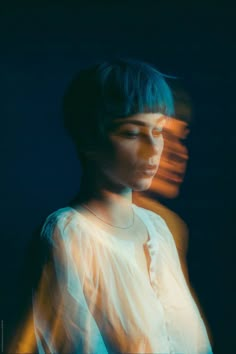 a woman with blue hair and white shirt