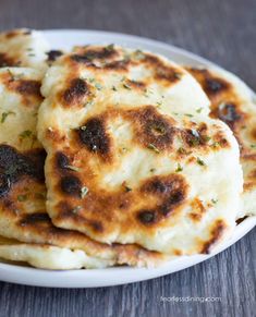 some food is on a white plate on a wooden table and it looks like they have been cooked