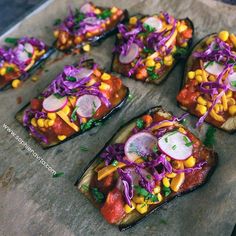 several pieces of bread topped with different types of veggies