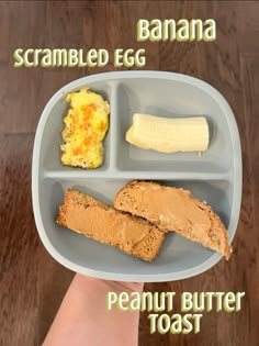 a person holding a banana and peanut butter toast in a plastic container on a wooden table