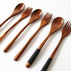 five wooden utensils lined up in a row