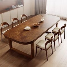 a wooden table with four chairs and a bowl of food on it in front of a window