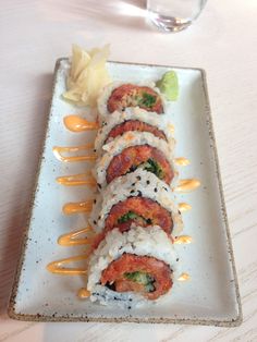 sushi rolls are arranged on a white plate