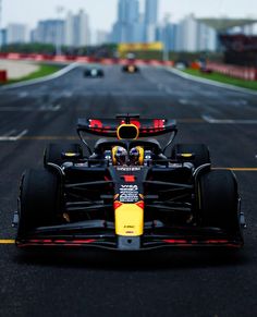 a red and yellow race car driving down the road