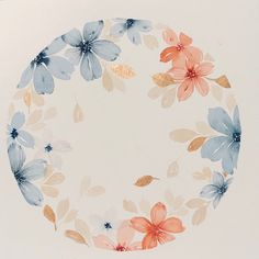 a white plate with blue, orange and pink flowers painted on the inside of it