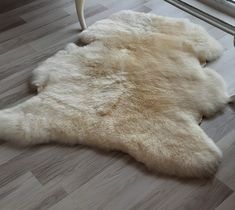 a sheepskin rug is laying on the floor