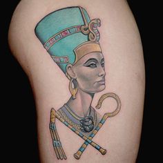 an egyptian tattoo design on the back of a woman's arm