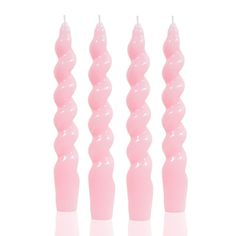 three pink candles sitting next to each other