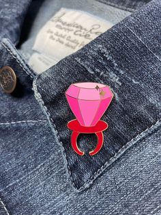 "The iconic, deliciously playful, wearable plastic ring with a large hard candy jewel now in miniature size! Perfect for the candy lover, and for some, even proposals! 1.5\" tall gold hard enamel pin Available in \"Blue Raspberry\" or \"Strawberry\" Double rubber pin back (Blue/Pink) All pins are fixed to a backing card and put in a clear bag to help get it safely to its new home. ------- B-grade pins also available! Almost perfect pins at a lower price! Imperfections are mostly slight scratches Novelty Brooch Jewelry Gift, Pink Enamel Pin For Gifts, Pink Enamel Pins For Gifts, Pink Enamel Pins As Gifts, Pink Enamel Pins As Gift, Pink Brooch For Valentine's Day Gift, Pink Brooches For Valentine's Day Gift, Round Enamel Brooches As Gift, Ring Pops