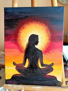 a painting of a woman meditating in front of the sun on an easel