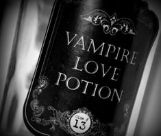 a bottle of vampire love potion sitting on top of a table next to a wall