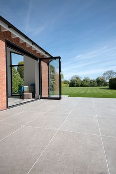 an empty patio with sliding glass doors leading to the back yard