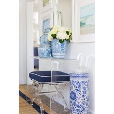 a blue and white vase sitting on top of a table next to a mirror in a room