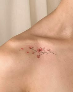 a woman's chest with small flowers on it