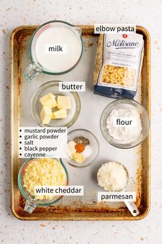 ingredients to make cheesecake on a baking tray with milk, flour, butter and other items