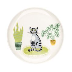 a white plate with a cat and plants on it