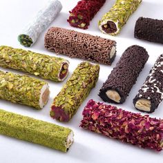 different types of food are arranged on a white surface, including rice sticks and sprinkles