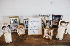 a wooden table topped with pictures and candles