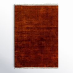 an orange area rug with fringes on it