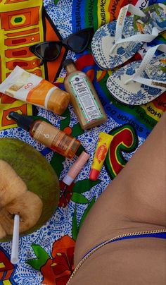 a woman laying on top of a colorful blanket covered in food and condiments