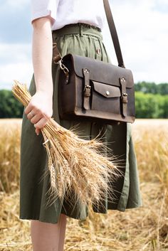 "This leather satchel manifests efficient storage, carrying comfort, and vintage elegance. Just right in size, this versatile leather briefcase holds as much as you need without looking bulky. Small internal and external pockets offer an apt spot for keeping essentials secured and organized. A detachable, adjustable shoulder strap and optional top handle allow you to wear it whichever suits your active lifestyle. Safe, neat belt buckles and patinaed leather bring a final touch of fine vintage.sa Leather Satchel Handbags, Model Features, Espresso Brown, Dark Brown Color, Leather Laptop, Leather Messenger Bag, Leather Briefcase, Satchel Purse, Leather Messenger