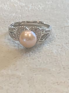 Silver colored S925 adjustable ring Heart design with pink freshwater Pearl in the center of the heart  Zircon embellishments  R-37 Ring Heart, Sterling Silver Heart, Adjustable Ring, Fashion Killa, Heart Design, Silver Heart, Adjustable Rings, Rings Statement, Silver Color