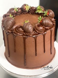 a chocolate cake with strawberries and chocolate icing