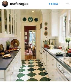 a kitchen with black and white checkered flooring next to a stove top oven