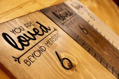 a wooden sign that says you are loved beyond measure