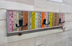 a wall mounted ruler with hooks on it