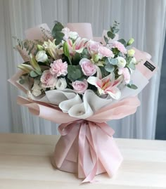 a bouquet of pink and white flowers on a table