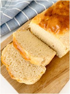 two loaves of bread sitting on top of a cutting board next to a blue towel