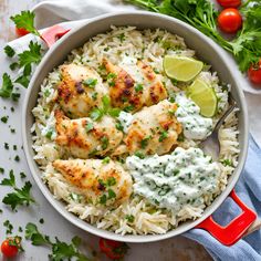 a bowl filled with rice, chicken and cilantro sauce