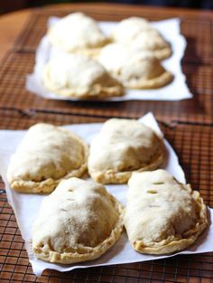 several pastries are sitting on top of some white napkins and cooling racking