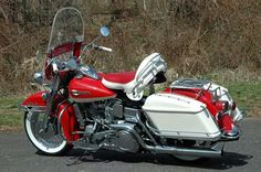 a red and white motorcycle parked on the street