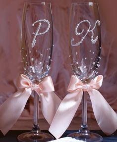 two wine glasses with bows and pearls on them