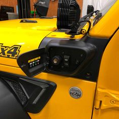 a close up of the front end of a yellow vehicle