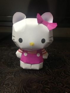 an origami hello kitty is sitting on a table