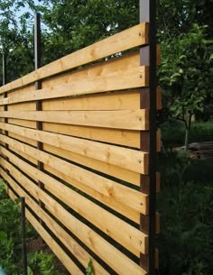 a wooden fence is shown in the woods