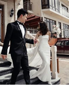 a bride and groom walking down the stairs