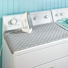 a white washer and dryer sitting next to each other on top of a counter