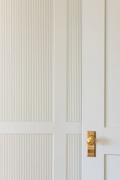 a white door with a gold handle on it