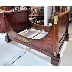 a wooden bed frame with gold trimming