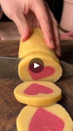 a person cutting up some food on top of a wooden table