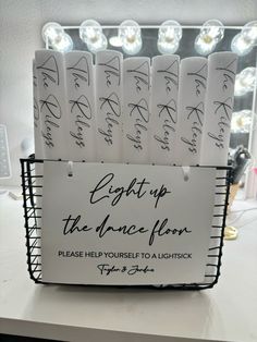 a basket with some writing on it sitting on top of a table in front of a mirror