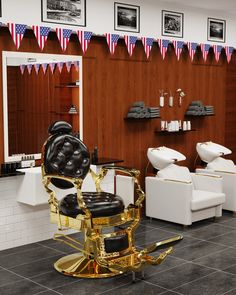 a barbershop with chairs and american flags on the wall behind it, in front of two sinks