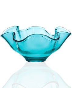 a blue glass bowl sitting on top of a white table