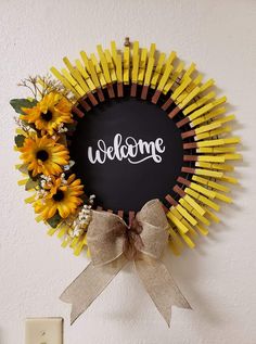 a welcome sign with sunflowers in the center and a ribbon tied around it