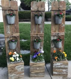 four wooden planters with flowers in them